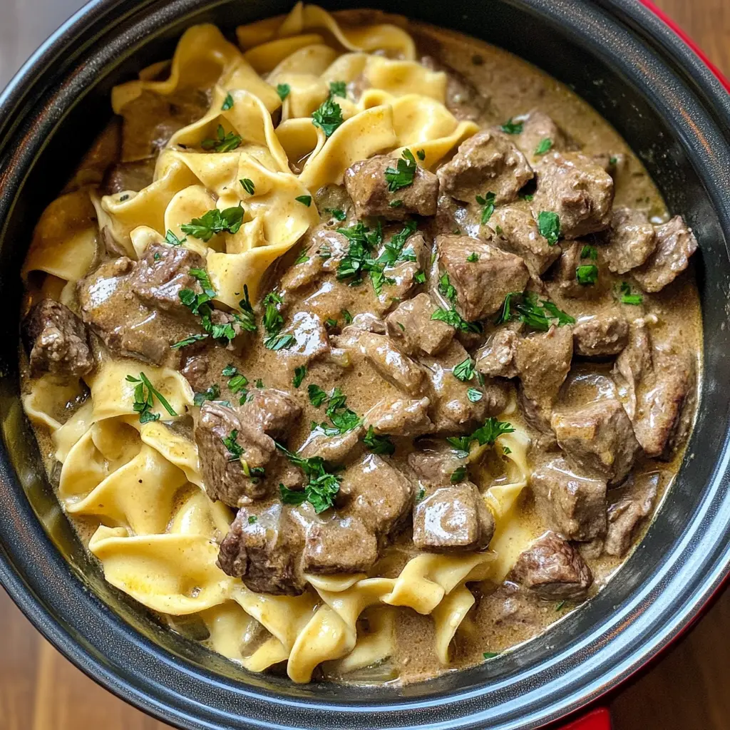 Cozy up with this flavorful Slow Cooker Beef Stroganoff! Tender beef and mushrooms meld beautifully in a creamy sauce that’s perfect over egg noodles or rice. Ready with minimal effort, it's the ideal dish for busy weeknights or a comforting family dinner. Save this recipe to enjoy a hearty meal that warms the soul!