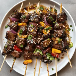 Juicy Asian Garlic Steak Skewers are perfect for your next BBQ! These flavorful skewers are marinated in a savory garlic soy sauce, bringing a delicious Asian twist to your grilling. Serve them at summer gatherings or weeknight dinners for a hit that's easy to make and delightful to eat. Save this recipe to impress your guests with tender, flavorful steak skewers!